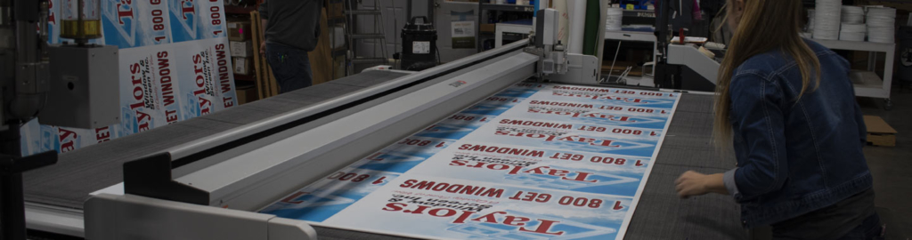 woman working with large printing equipment